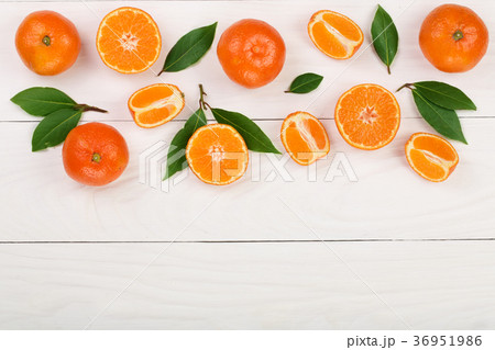 tangerine with leaves on white wooden background tangerine with leaves on white wooden background 36951986