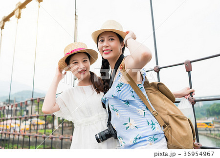 Girls posing for photography on bridge Girls posing for photography on bridge 36954967