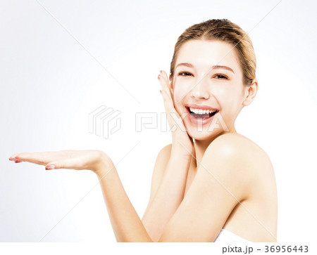 young woman showing beauty product on her hand 36956443