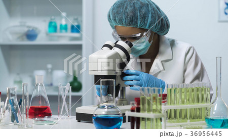 Professional laboratory scientist looking into 36956445