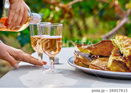 Female hands pour refreshing pink wine in a glass Female hands pour refreshing pink wine in a glass 36957615