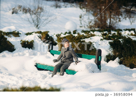 A boy warms his hands from the cold in winter 36958094