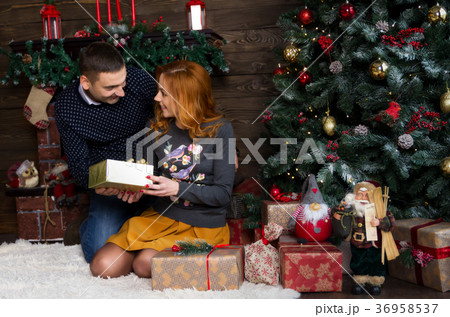 Happy young people give each other gifts Happy young people give each other gifts 36958537