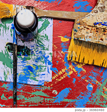 Paints and brushes on dirty background 36960460