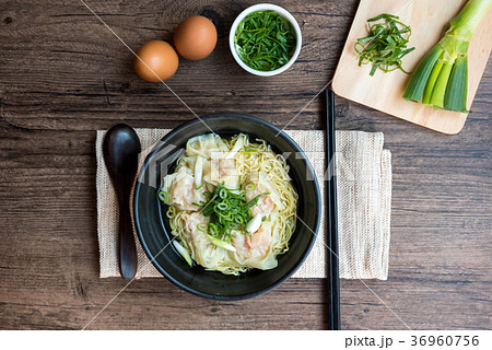 Shrimp wonton with braised pork in soup on table  36960756