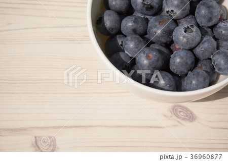 Blueberries in a white round bowl. 36960877