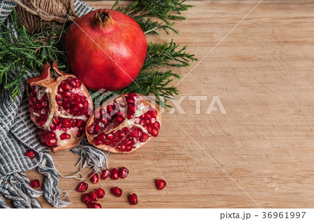 Healthy fresh pomegranate, fabric, green leaves Healthy fresh pomegranate, fabric, green leaves 36961997