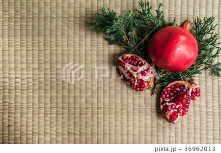 Ripe pomegranate fruit isolated on tatami top view 36962013