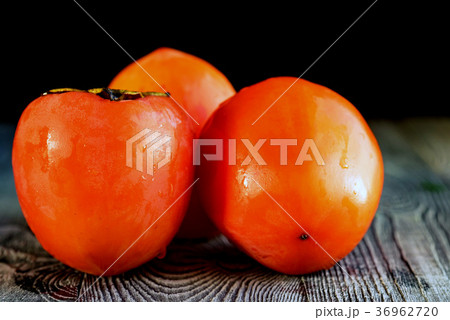 Ripe persimmons with water drops. Selective focus Ripe persimmons with water drops. Selective focus 36962720