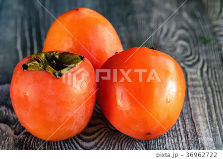 Ripe persimmons with water drops. Selective focus Ripe persimmons with water drops. Selective focus 36962722