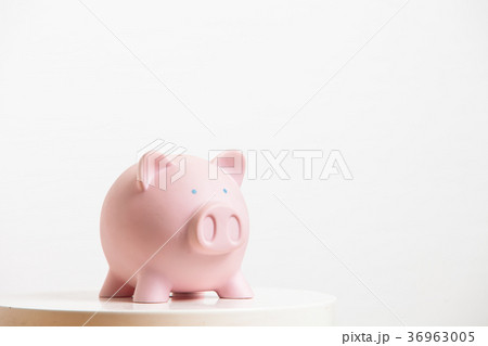 Pink piggy-bank on the table 36963005