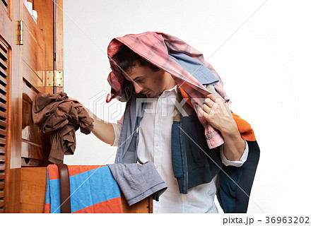 man choosing clothes man choosing clothes 36963202