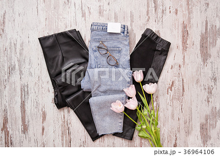 Blue jeans and black leather leggings, glasses Blue jeans and black leather leggings, glasses 36964106