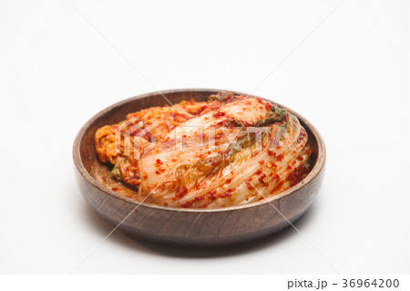 Kimchi in a wooden bowl isolated Kimchi in a wooden bowl isolated 36964200