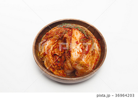 Kimchi in a wooden bowl isolated Kimchi in a wooden bowl isolated 36964203