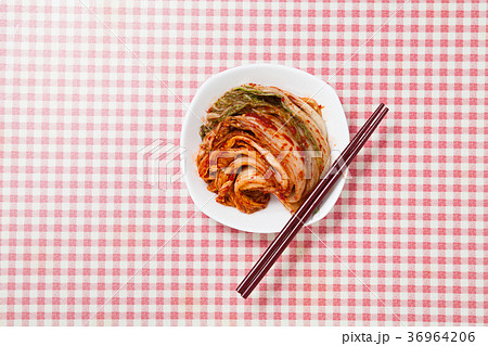 Kimchi with chopsticks in a dish 36964206