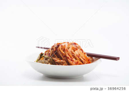 Kimchi in white dish with chopsticks isolated Kimchi in white dish with chopsticks isolated 36964256