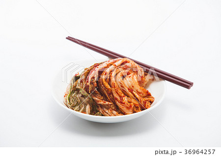 Kimchi in white dish with chopsticks isolated Kimchi in white dish with chopsticks isolated 36964257