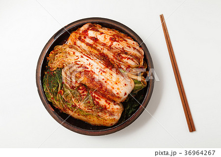 Chopsticks with kimchi in crock head isolated 36964267