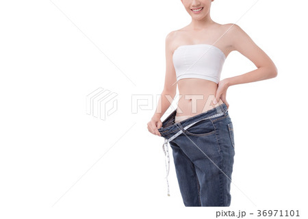 Slim woman in her old big trousers over white Slim woman in her old big trousers over white 36971101