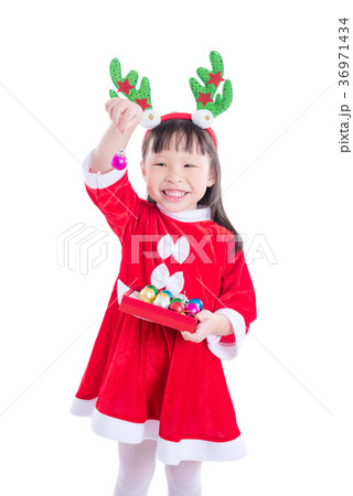 girl wearing santa claus dress holding ball  36971434