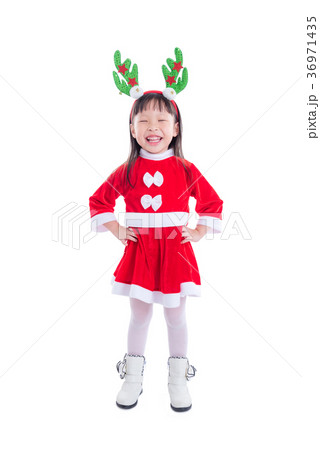 Little girl wearing santa claus dress smiles 36971435