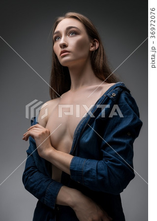 Attractive sexy blonde posing against gray wall 36972076