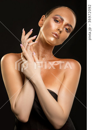 Beautiful brunette with gold skin artisitc shot 36972092