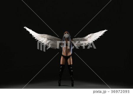 Conceptual shot of a sexy woman with white wings 36972093