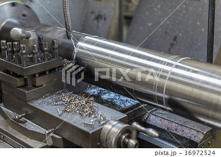The  lathe machine cutting the steel rod  36972524