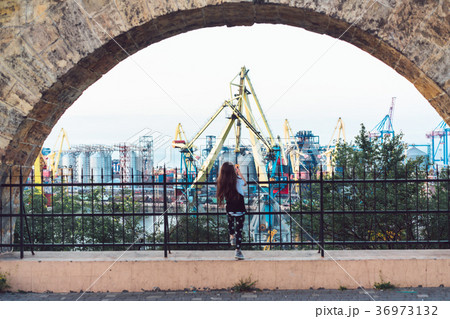 Little girl playing at fence 36973132
