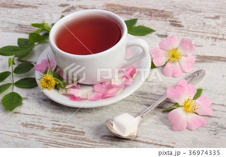 Cup of tea and wild rose flower 36974335