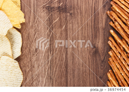 Frame of breadsticks and crisps 36974454