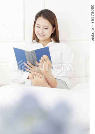 若い女性 読書 ベッド 36978080