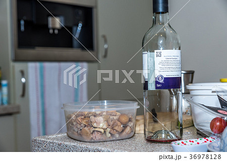 Empty bottle of red non alcoholic wine next to 36978128