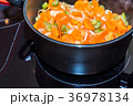 Fresh carrots and onions frying in pan casserole 36978134