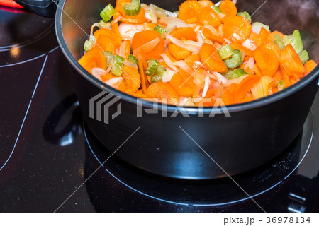 Fresh carrots and onions frying in pan casserole 36978134