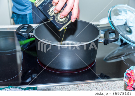 Closeup view pouring vegetable olive oil into 36978135