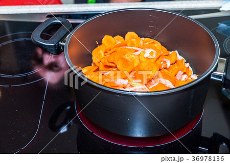 Fresh carrots and onions frying in pan casserole 36978136