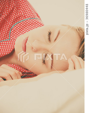 Woman sleeping in bed on the side Woman sleeping in bed on the side 36980448