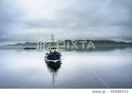 Alone boat driving through in the foggy sea in the Alone boat driving through in the foggy sea in the 36980452