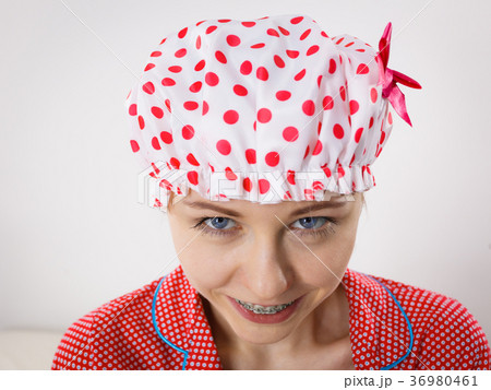 Funny woman wearing pajamas and bathing cap 36980461