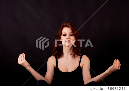 Girl in Studio on dark background. Red hair, great 36981231