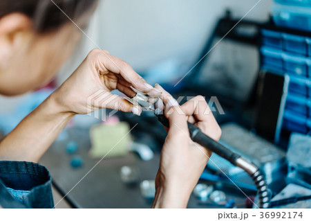 The girl is engaged in jewelry business 36992174