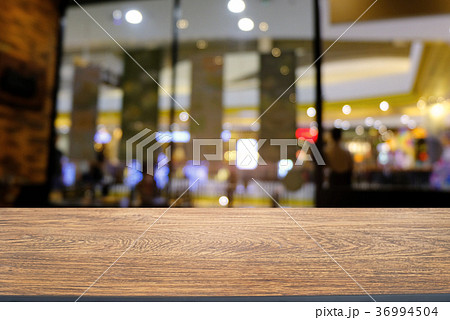 Empty wood table top and blur of night market Empty wood table top and blur of night market 36994504
