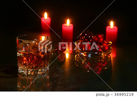 glass of cognac or whiskey, christmas candles glass of cognac or whiskey, christmas candles 36995219