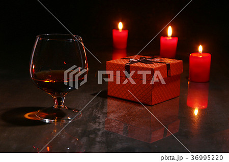 glass of cognac or whiskey, christmas candles glass of cognac or whiskey, christmas candles 36995220