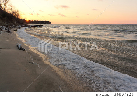 Ice forming on the river in autumn at sunset Ice forming on the river in autumn at sunset 36997329