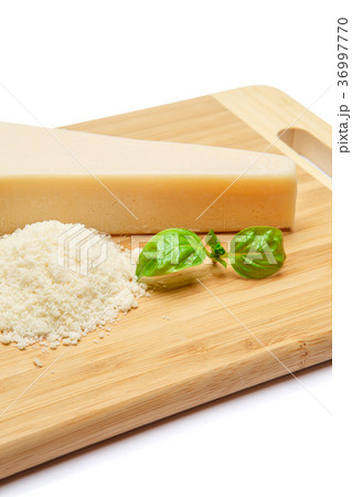 a piece of Parmesan and grated cheese on cutting 36997770