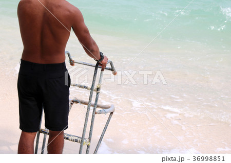 Lifeguards with ladders for the boat on the beach 36998851